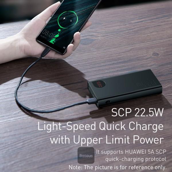 Person charging a phone with a power bank on a wooden surface, featuring Besouts branding.