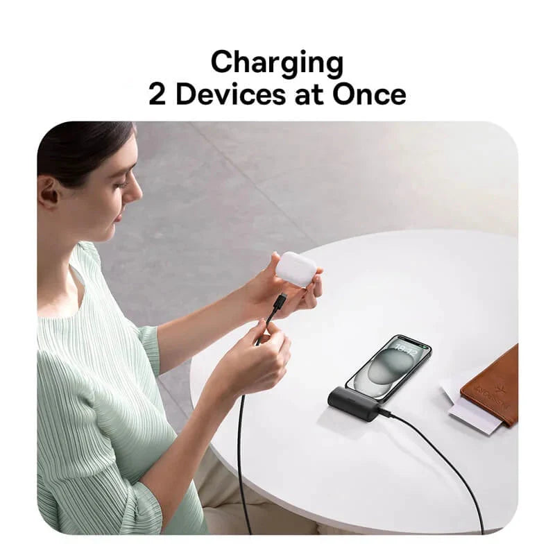 Woman using a baseus charging cable to charge two devices at once, with the brand logo visible.